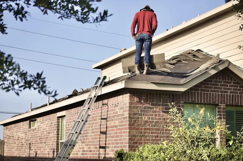 Professional roofer working on a residential roof in Quaker Settlement